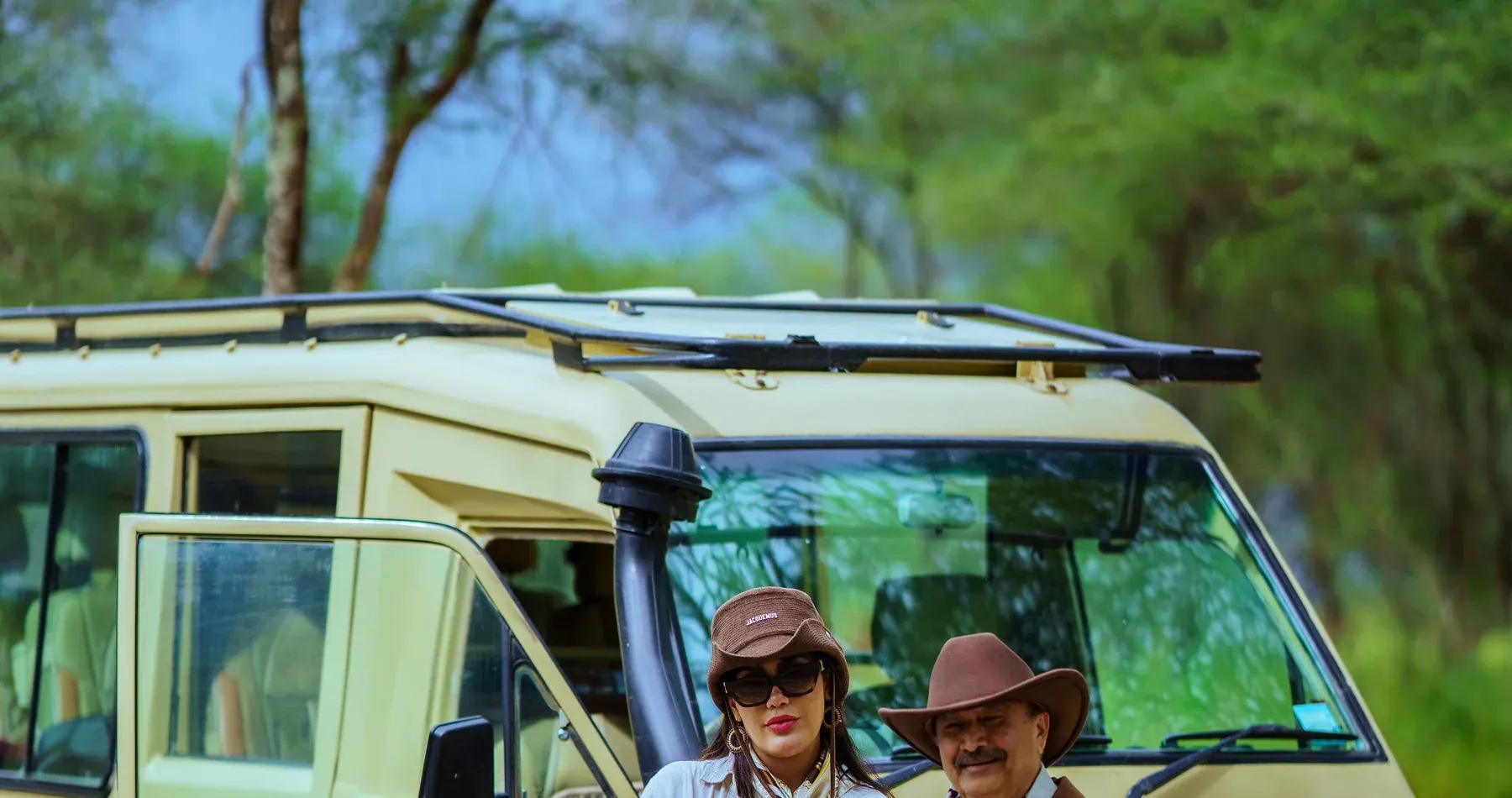 Travelers beside a TanzaLux safari vehicle in northern Tanzania